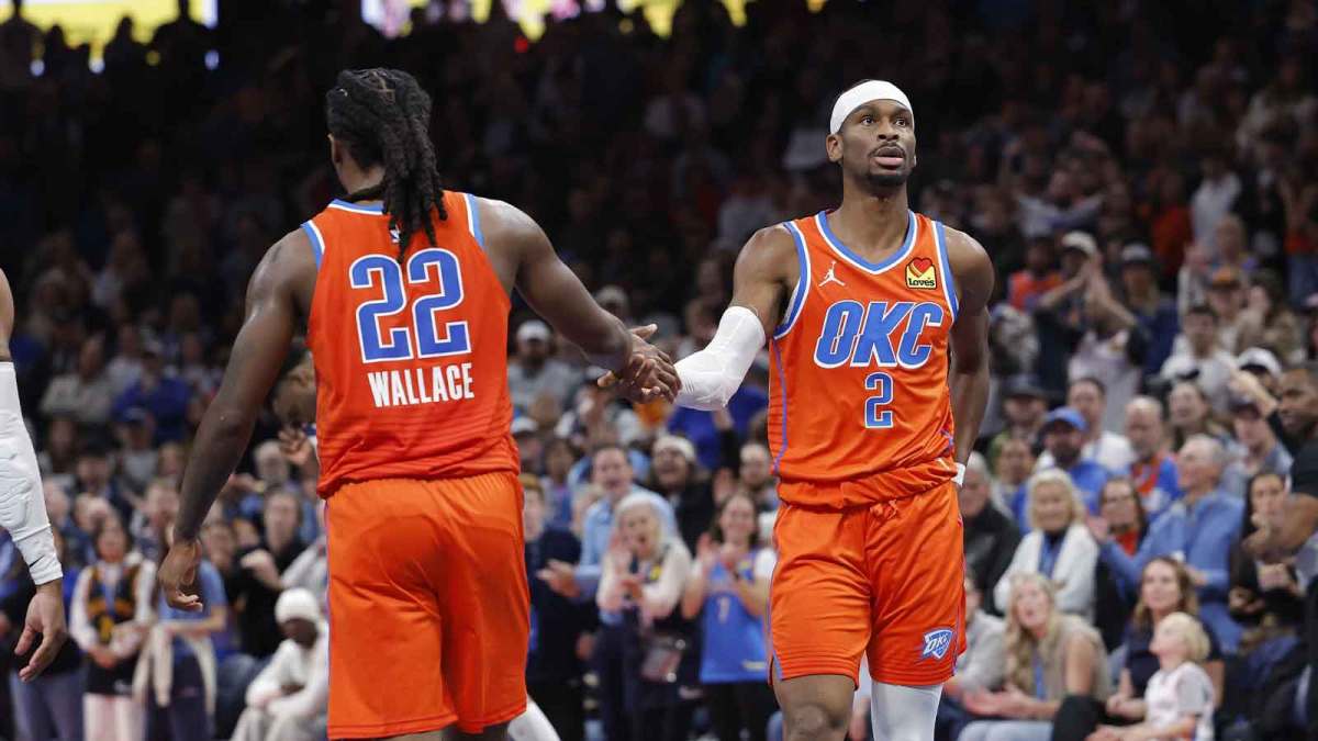 Thunder guard Shai Gilgeous-Alexander (2) high fives Oklahoma City Thunder guard Cason Wallace (22) after a play against the Minnesota Timberwolves during the second half at Paycom Center