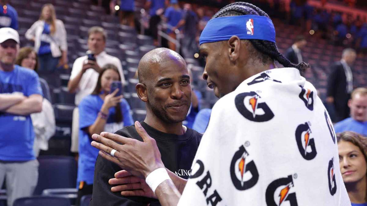Thunder guard Shai Gilgeous-Alexander (2) talks to Chris Paul after defeating the Minnesota Timberwolves during game two of the western conference finals for the 2025 NBA Playoffs at Paycom Center with Mark Daigneault in the background