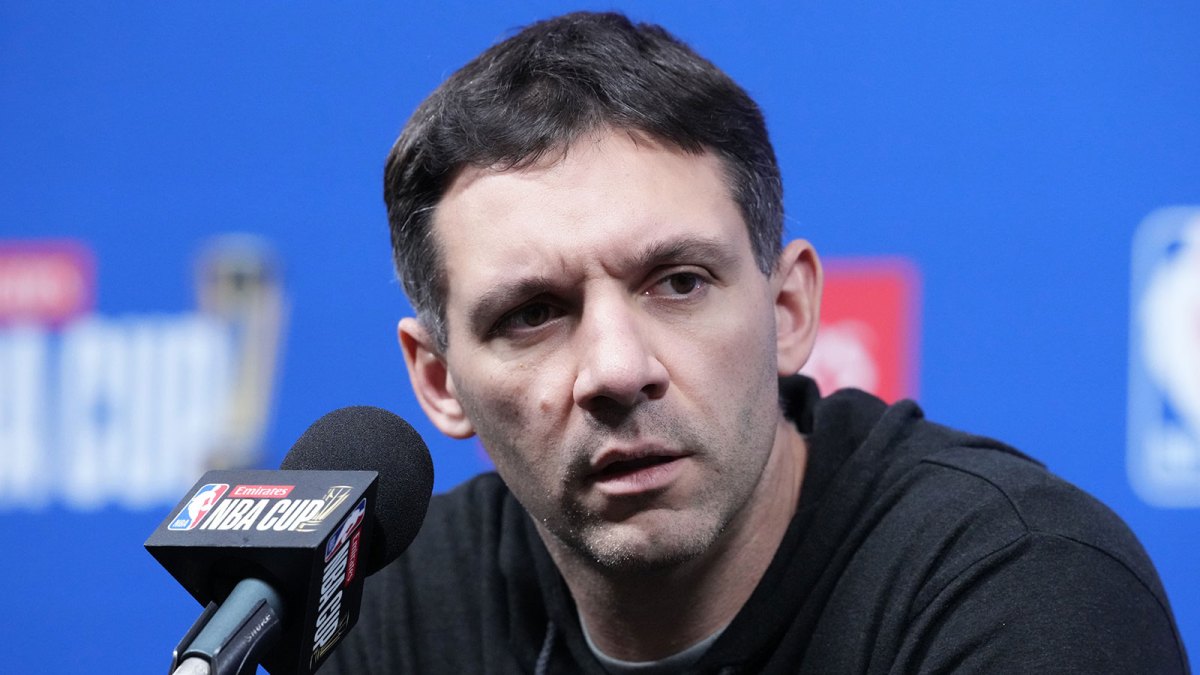 Thunder head coach Mark Daigneault at press conference prior to the Emirates Cup semifinals at T-Mobile Arena with Spurs Victor Wembanyama in the background