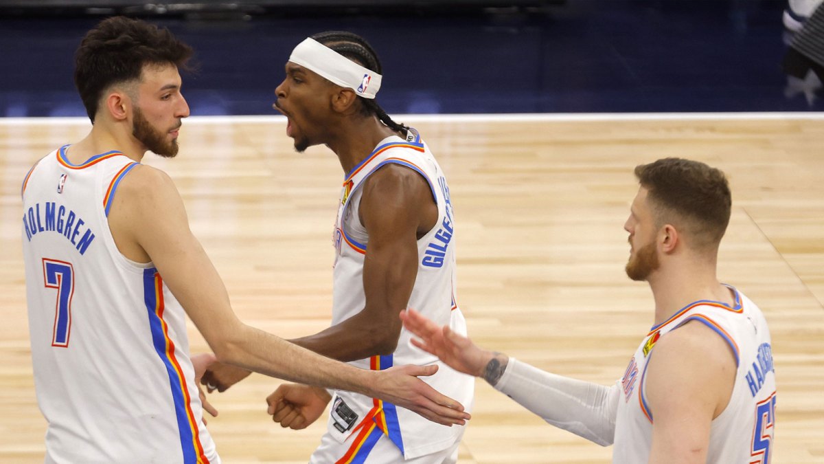 Thunder forward Chet Holmgren (7), guard Shai Gilgeous-Alexander (2) and center Isaiah Hartenstein (55) react after defeating the Minnesota Timberwolves in game four of the western conference finals for the 2025 NBA Playoffs at Target Center with the Spurs logo and the Thunder starting 5 in the background