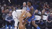 Thunder guard Cason Wallace (22) defends a drive by Los Angeles Clippers guard Bogdan Bogdanovic (10) during the first quarter at Paycom Center