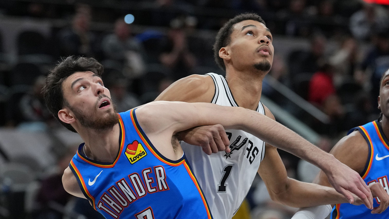 Thunder forward Chet Holmgren (7) and San Antonio Spurs center Victor Wembanyama (1) battle for position in the first half at Frost Bank Center