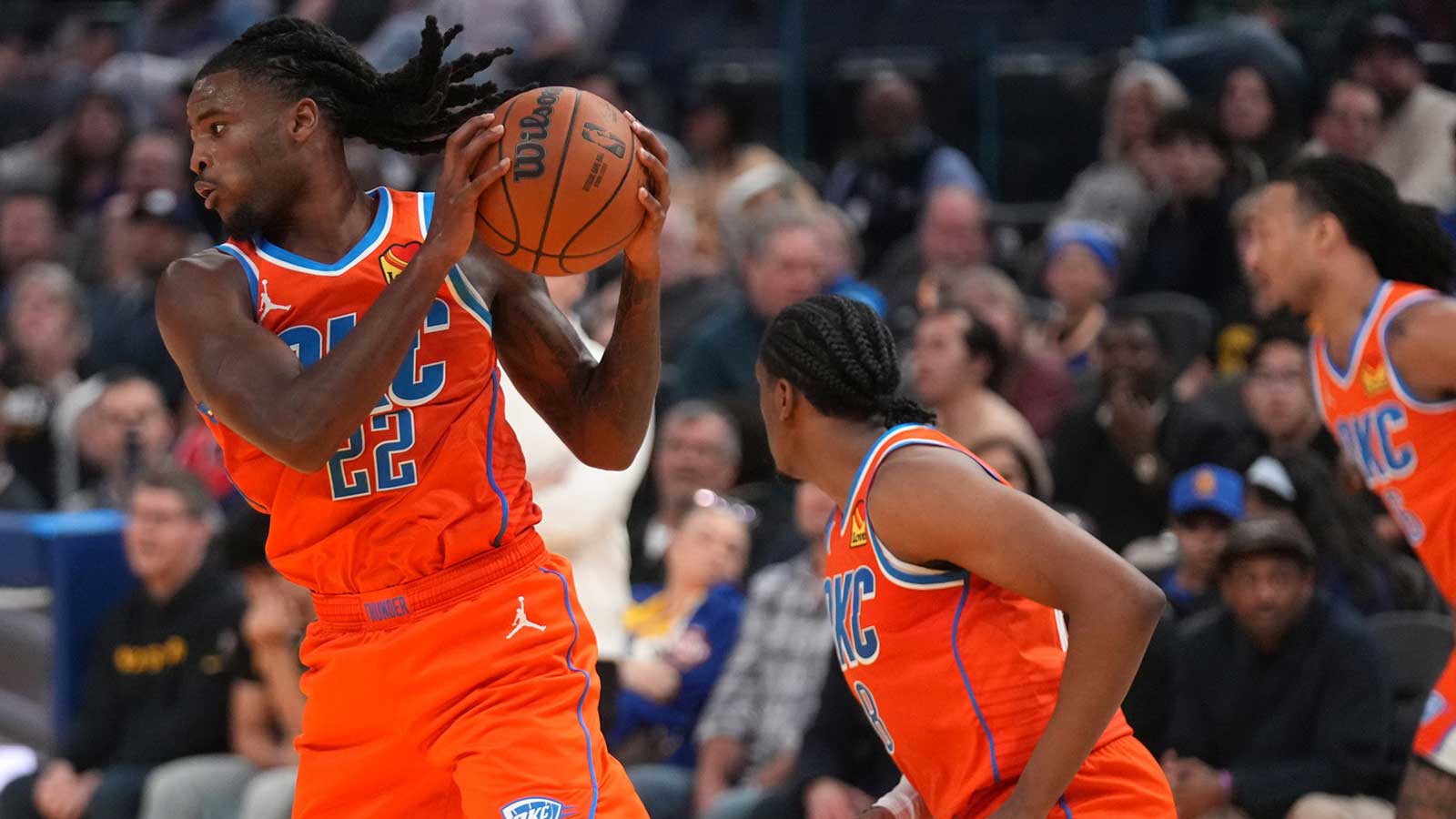 Thunder guard Cason Wallace (22) holds onto a rebound against the Golden State Warriors in the second quarter at the Chase Center