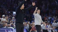 Spurs head coach Mitch Johnson and Oklahoma City Thunder head coach Mark Daigneault gesture to their teams during the second half at Paycom Center with Spurs' Victor Wembanyama in the background