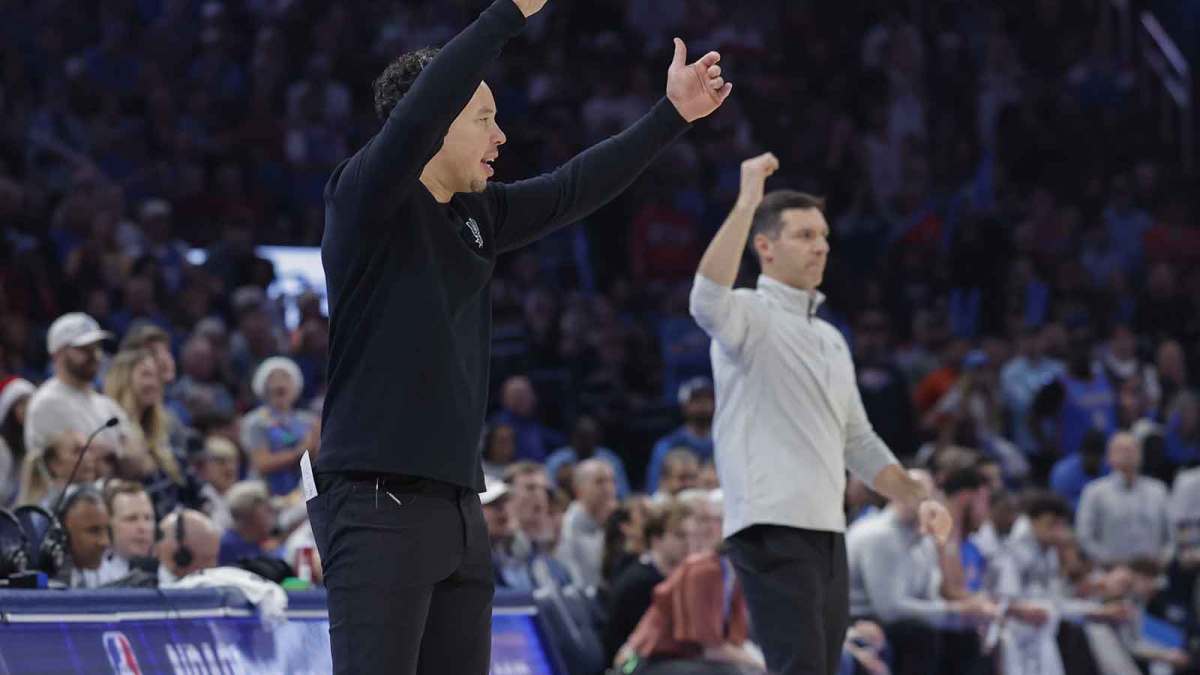 Spurs head coach Mitch Johnson and Oklahoma City Thunder head coach Mark Daigneault gesture to their teams during the second half at Paycom Center with Spurs' Victor Wembanyama in the background
