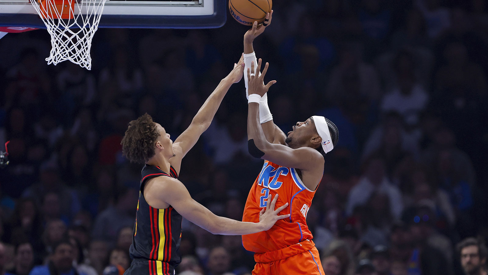 Thunder guard Shai Gilgeous-Alexander (2) shoots as Atlanta Hawks guard Dyson Daniels (5) defends the shot during the first quarter at Paycom Center