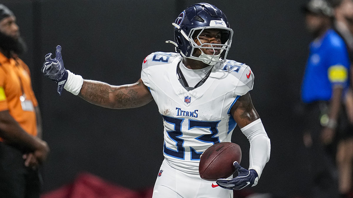Tennessee Titans safety Kendell Brooks (33) reacts after running for a touchdown after intercepting a pass against the Atlanta Falcons during the first half at Mercedes-Benz Stadium.