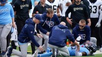 Tennessee Titans cornerback Jalyn Armour-Davis (18) is checked out by staff after an injury during the first quarter against the New Orleans Saints at Nissan Stadium.