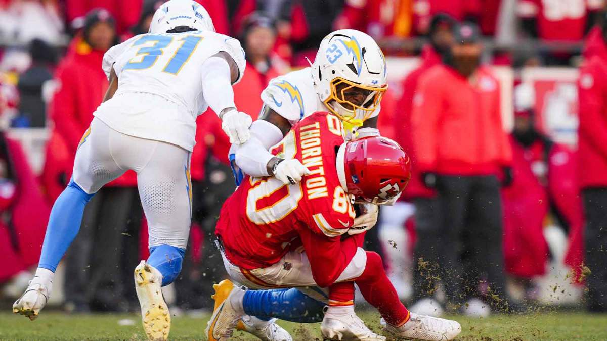 Los Angeles Chargers safety Tony Jefferson (23) tackles Kansas City Chiefs wide receiver Tyquan Thornton (80) with a helmet-to-helmet hit during the fourth quarter at GEHA Field at Arrowhead Stadium. Jefferson was ejected for the play.