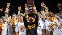 Tennessee head coach Tony Vitello holds up the trophy after game three of the NCAA College World Series finals between Tennessee and Texas A&M at Charles Schwab Field.