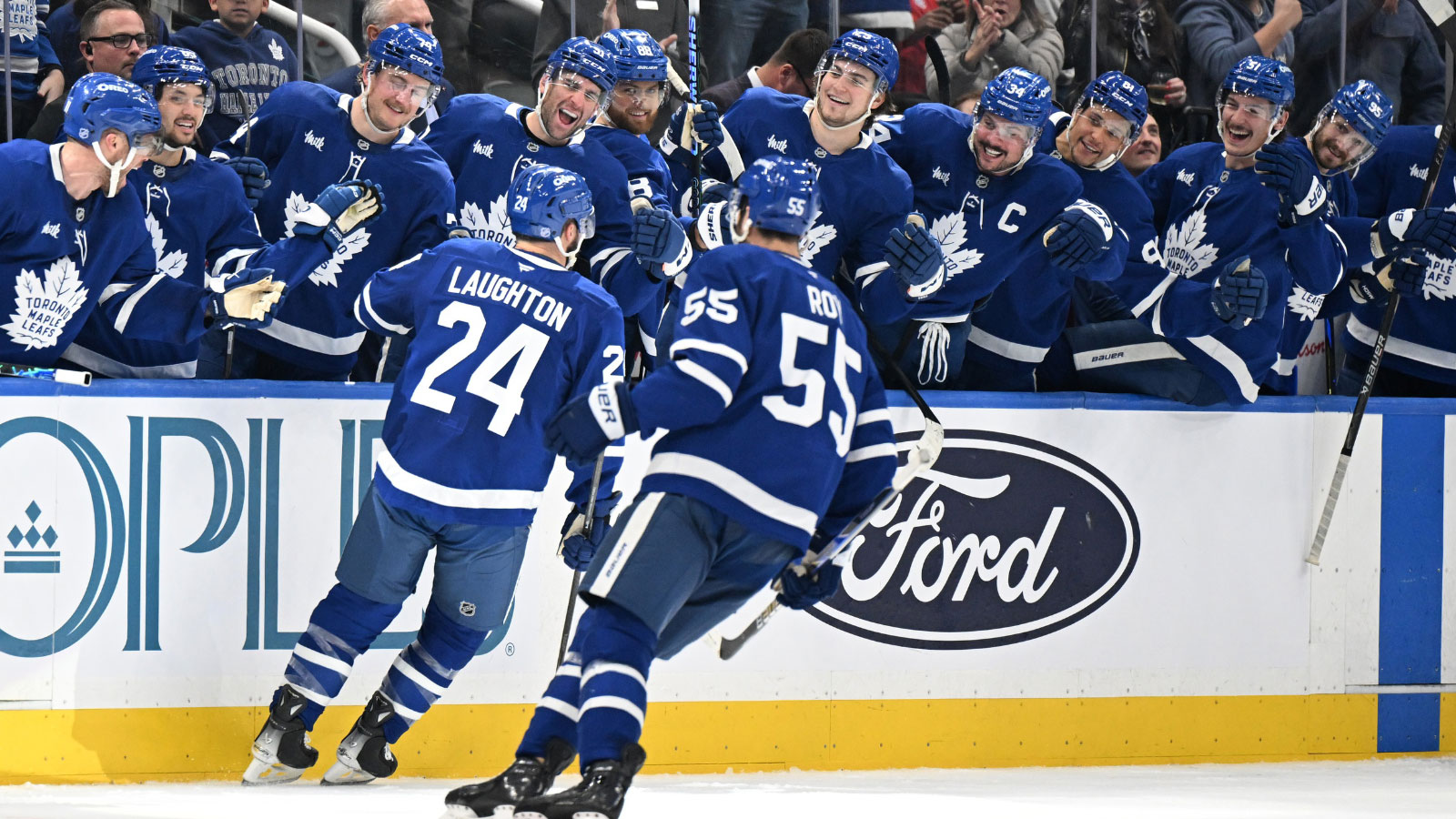 Toronto Maple Leafs forward Scott Laughton (24) celebrates with team mates at the bench after scoring a goal against the Montreal Canadiens in the third period at Scotiabank Arena.
