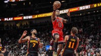 Chicago Bulls guard Ayo Dosunmu (11) drives to the basket against Atlanta Hawks guard Trae Young (11) during the second half at State Farm Arena.