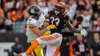 Pittsburgh Steelers tight end Pat Freiermuth (88) battles for the ball against Cincinnati Bengals cornerback Tre Flowers (33) in overtime at Paycor Stadium.