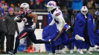 New England Patriots running back Treveyon Henderson (32) runs the ball for a touchdown against Buffalo Bills safety Cole Bishop (24) in the first half at Gillette Stadium.