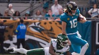 Jacksonville Jaguars quarterback Trevor Lawrence (16) eludes New York Jets cornerback Azareye'H Thomas (23) in the second quarter during an NFL football game at EverBank Stadium