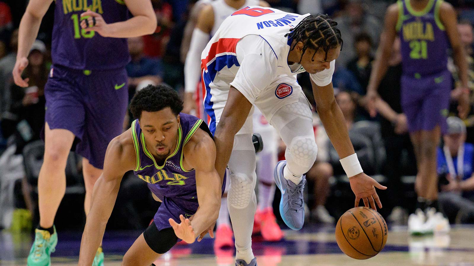 New Orleans Pelicans guard Trey Murphy III (25) falls after a steal by Detroit Pistons forward Ausar Thompson (9) during the first quarter at Smoothie King Center.