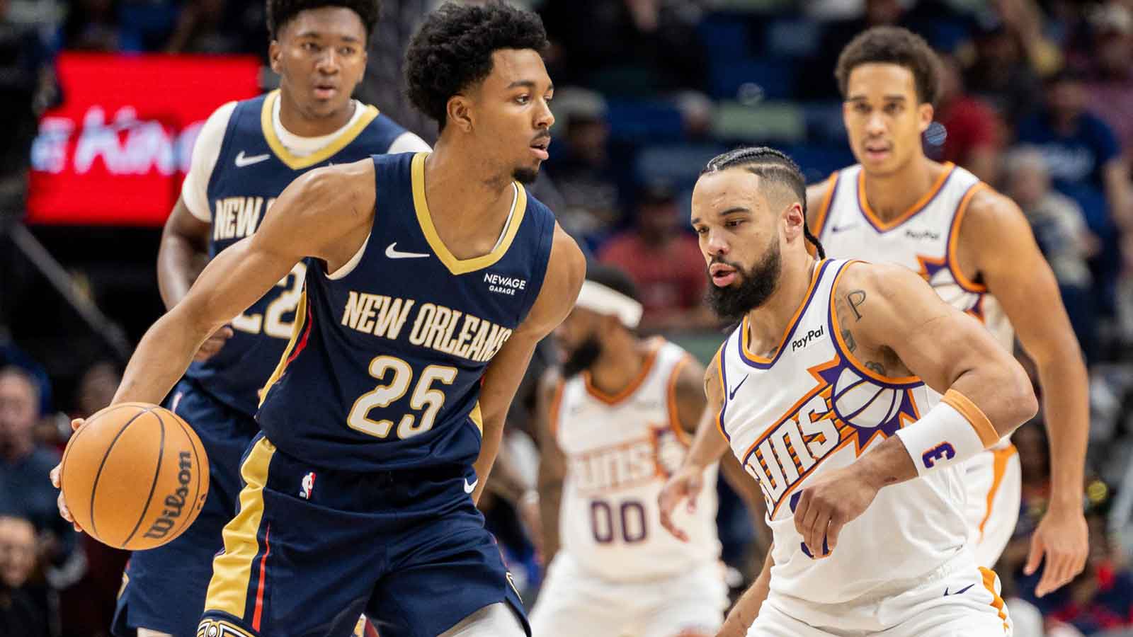 New Orleans Pelicans forward Trey Murphy III (25) dribbles against Phoenix Suns guard/forward Dillon Brooks (3) during the first half at Smoothie King Center.