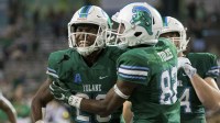 Tulane Green Wave running back Dontrell Hilliard (26) scores a touchdown on a 16 yard run against South Florida Bulls safety Devin Abraham (20) in the fourth quarter at Yulman Stadium. against the South Florida won 34-28.