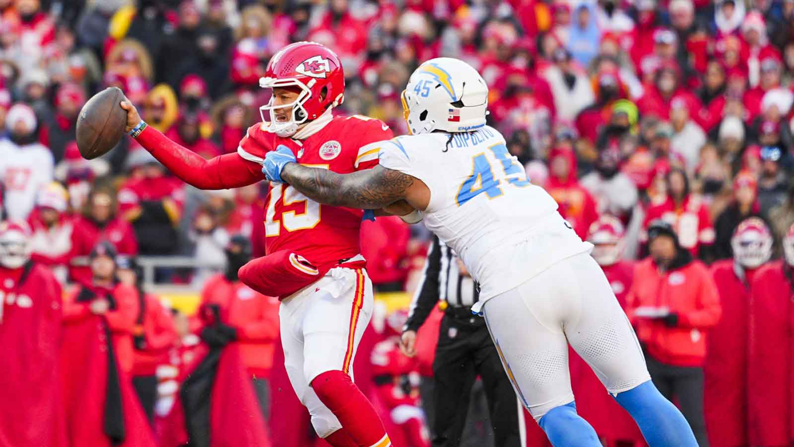 Los Angeles Chargers linebacker Tuli Tuipulotu (45) pressures Kansas City Chiefs quarterback Patrick Mahomes (15) during the fourth quarter at GEHA Field at Arrowhead Stadium. 