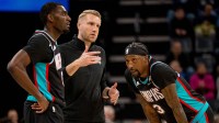 Memphis Grizzlies head coach Tuomas Iisalo talks to guard Vince Williams Jr. (5) and forward Cedric Coward (23) during a timeout in the first half against the Utah Jazz at FedExForum.