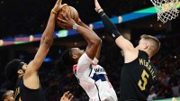 Washington Wizards guard Carlton Carrington (8) drives to the basket between Cleveland Cavaliers center Jarrett Allen (31) and guard Sam Merrill (5) during the first half at Rocket Mortgage FieldHouse.