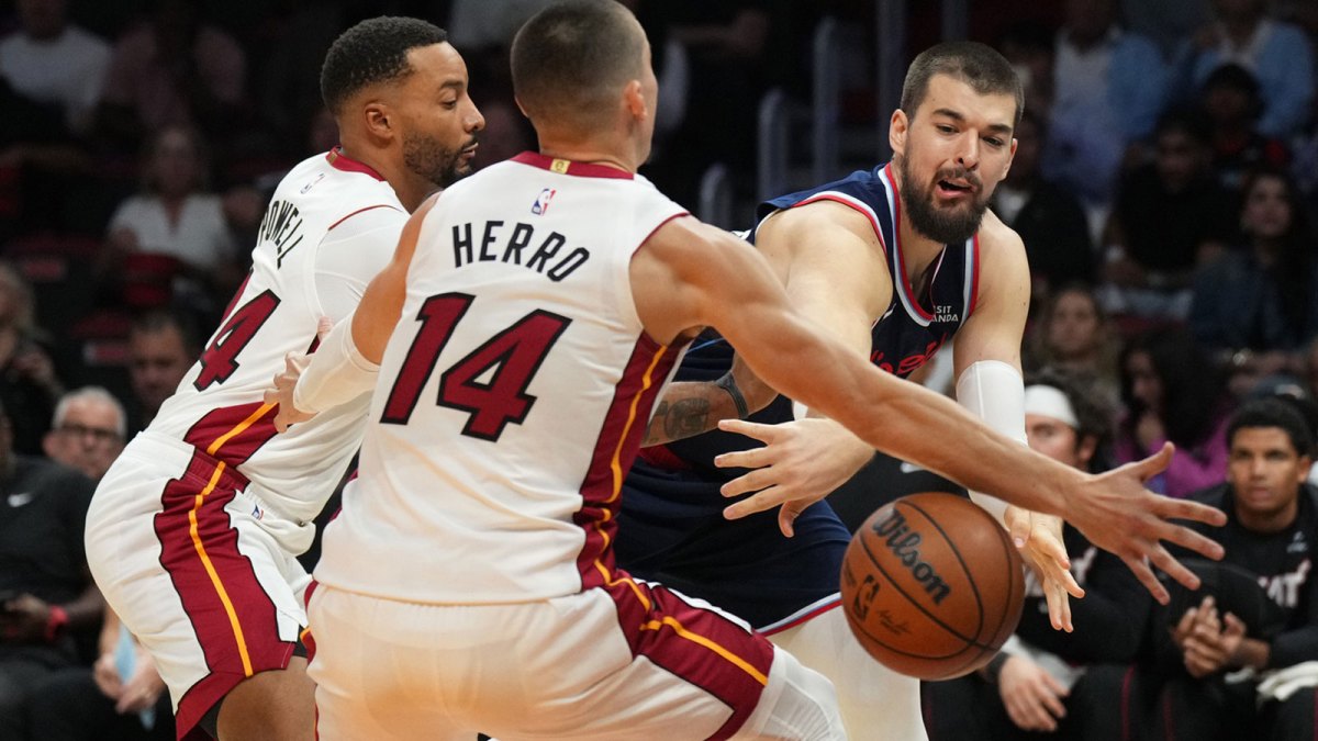 Los Angeles Clippers center Ivica Zubac (40) makes a pass around Miami Heat guard Tyler Herro (14) and guard Norman Powell (24) during the first half at Kaseya Center.