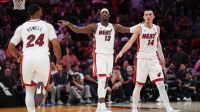 Miami Heat center Bam Adebayo (13), guard Norman Powell (24) and guard Tyler Herro (14) get back on defense against the Los Angeles Clippers during the second half at Kaseya Center.
