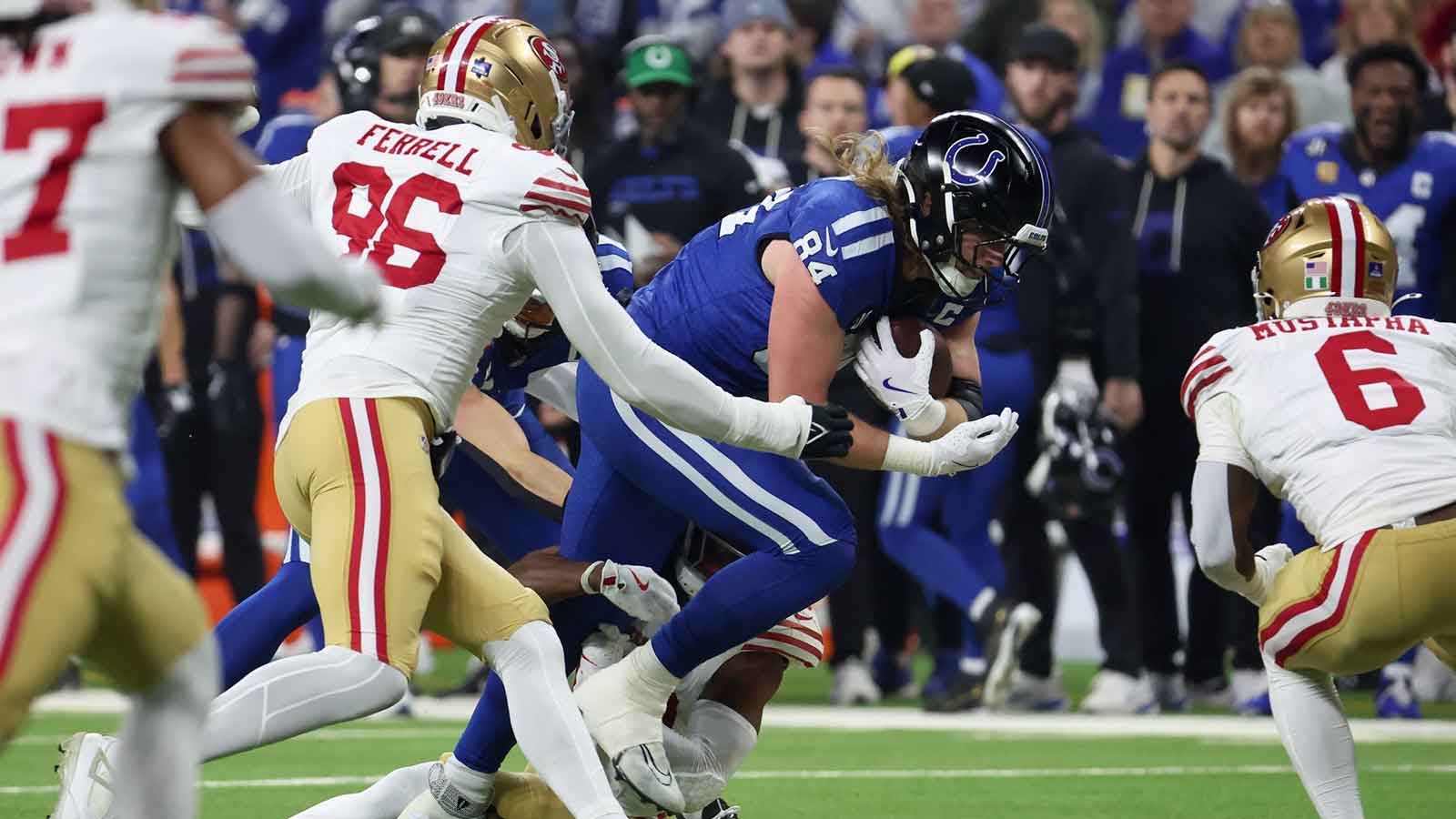 Indianapolis Colts tight end Tyler Warren (84) is tackled by the San Francisco 49ers in the first quarter of the game at Lucas Oil Stadium.