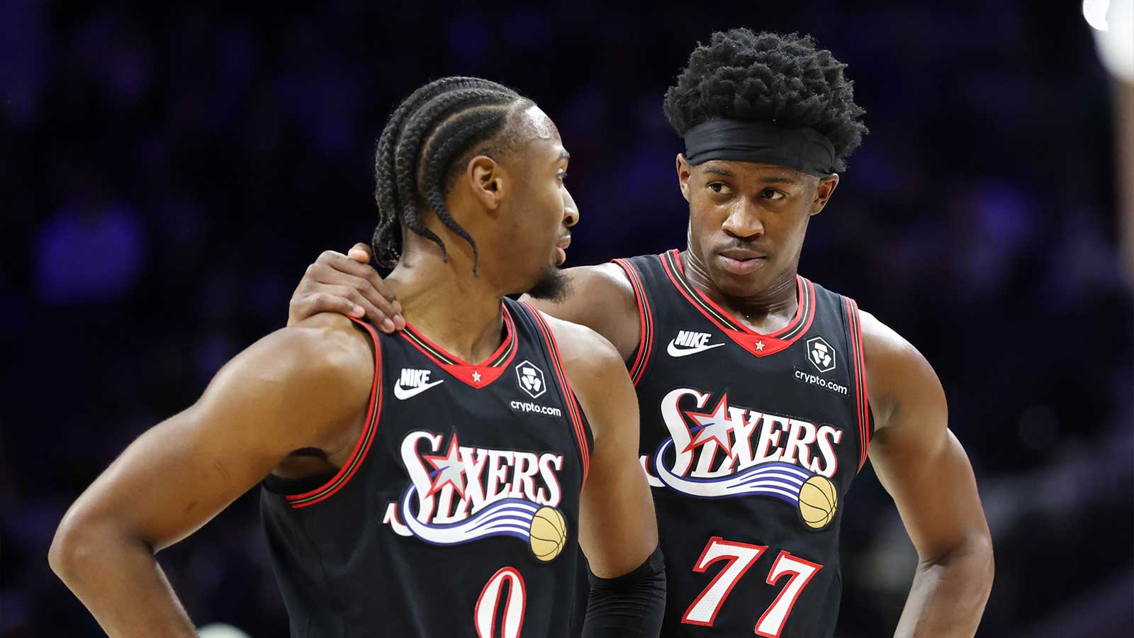 Philadelphia 76ers guard Tyrese Maxey (0) and guard Vj Edgecombe (77) talks during a break in action against the Dallas Mavericks in the fourth quarter at Xfinity Mobile Arena.