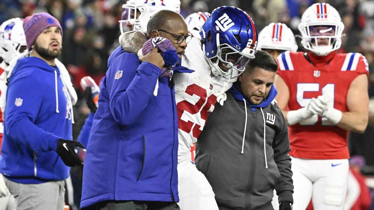 New York Giants running back Tyrone Tracy Jr. (29) is helped off the field during the fourth quarter against the New England Patriots at Gillette Stadium.