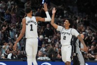 San Antonio Spurs forward Victor Wembanyama (1) and guard Dylan Harper (2) celebrates in the second half against the Brooklyn Nets at Frost Bank Center.