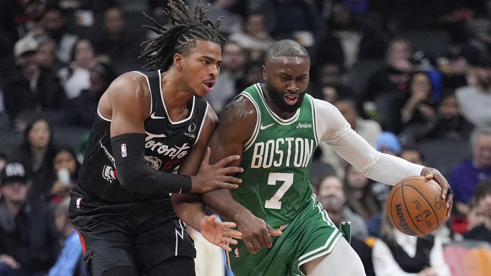 Toronto Raptors forward Collin Murray-Boyles (12) tries to slow up Boston Celtics forward Jaylen Brown (7) during the first half at Scotiabank Arena.