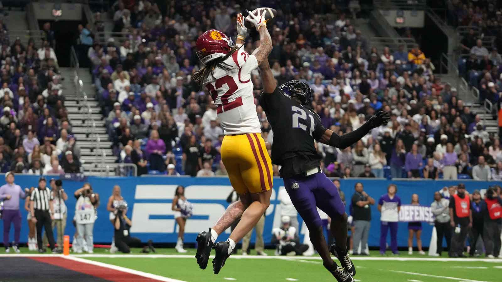 Southern California Trojans running back Bryan Jackson (21) attempts to catch the ball against TCU Horned Frogs safety Bud Clark (21) in the first half during the Alamo Bowl at Alamodome.