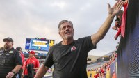 Utah Utes head coach Kyle Whittingham celebrates with fans after defeating the West Virginia Mountaineers at Milan Puskar Stadium.