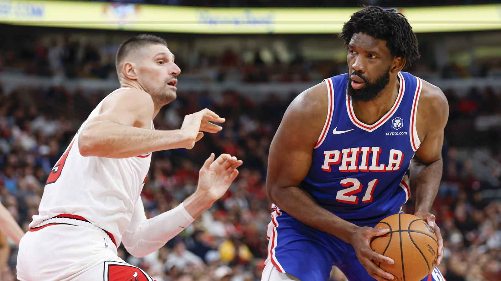 Chicago Bulls center Nikola Vucevic (9) defends against Philadelphia 76ers center Joel Embiid (21) during the second half at United Center.