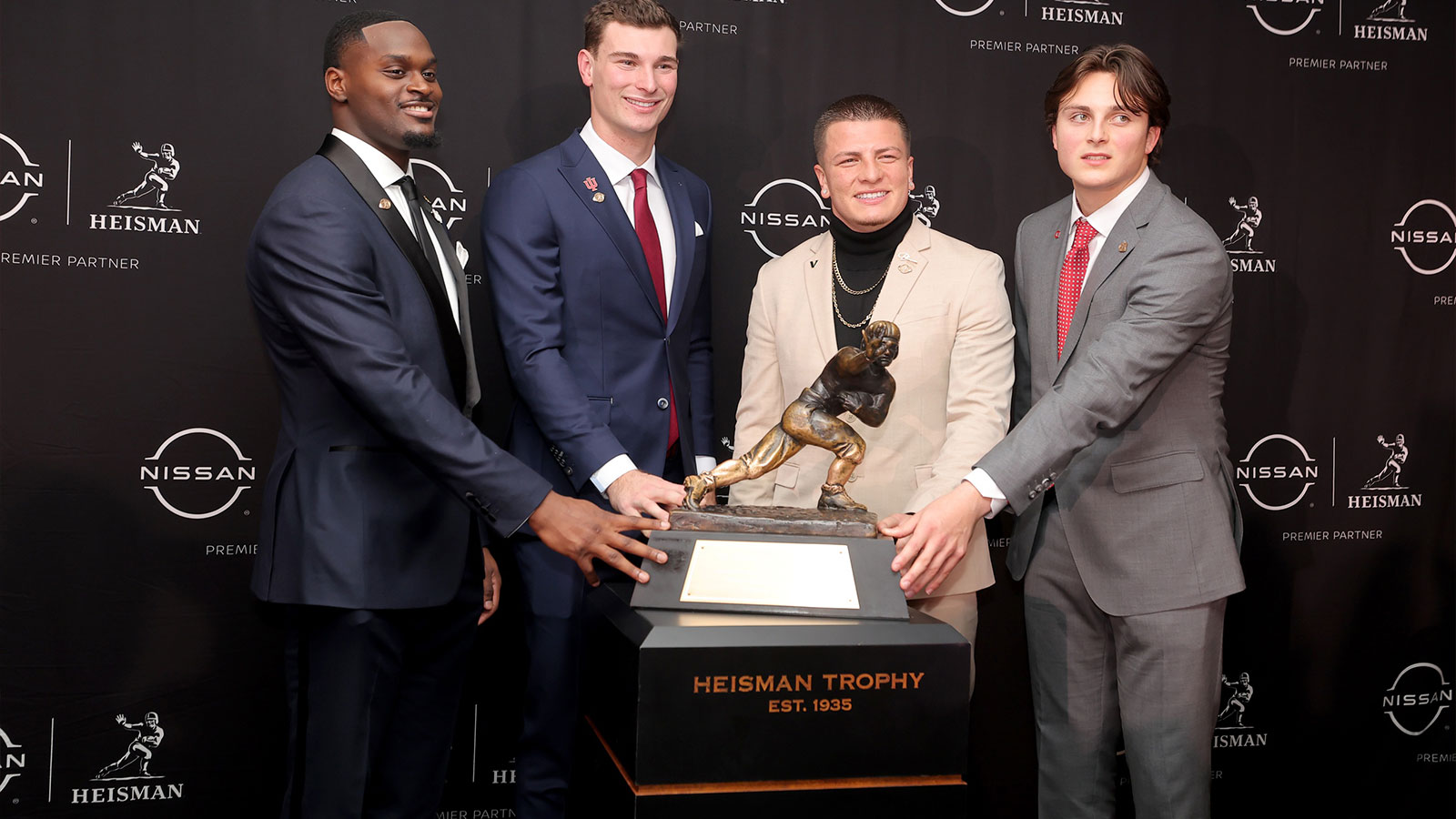 Notre Dame Fighting Irish running back Jeremiyah Love (left to right) and Indiana Hoosiers quarterback Fernando Mendoza and Vanderbilt Commodores quarterback Diego Pavia and Ohio State Buckeyes quarterback Julian Sayin pose with the Heisman trophy during a press conference at the New York Marriott Marquis.