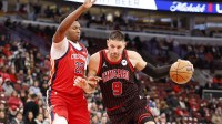 Chicago Bulls center Nikola Vucevic (9) drives to the basket against New Orleans Pelicans center Derik Queen (22) during the first half at United Center.