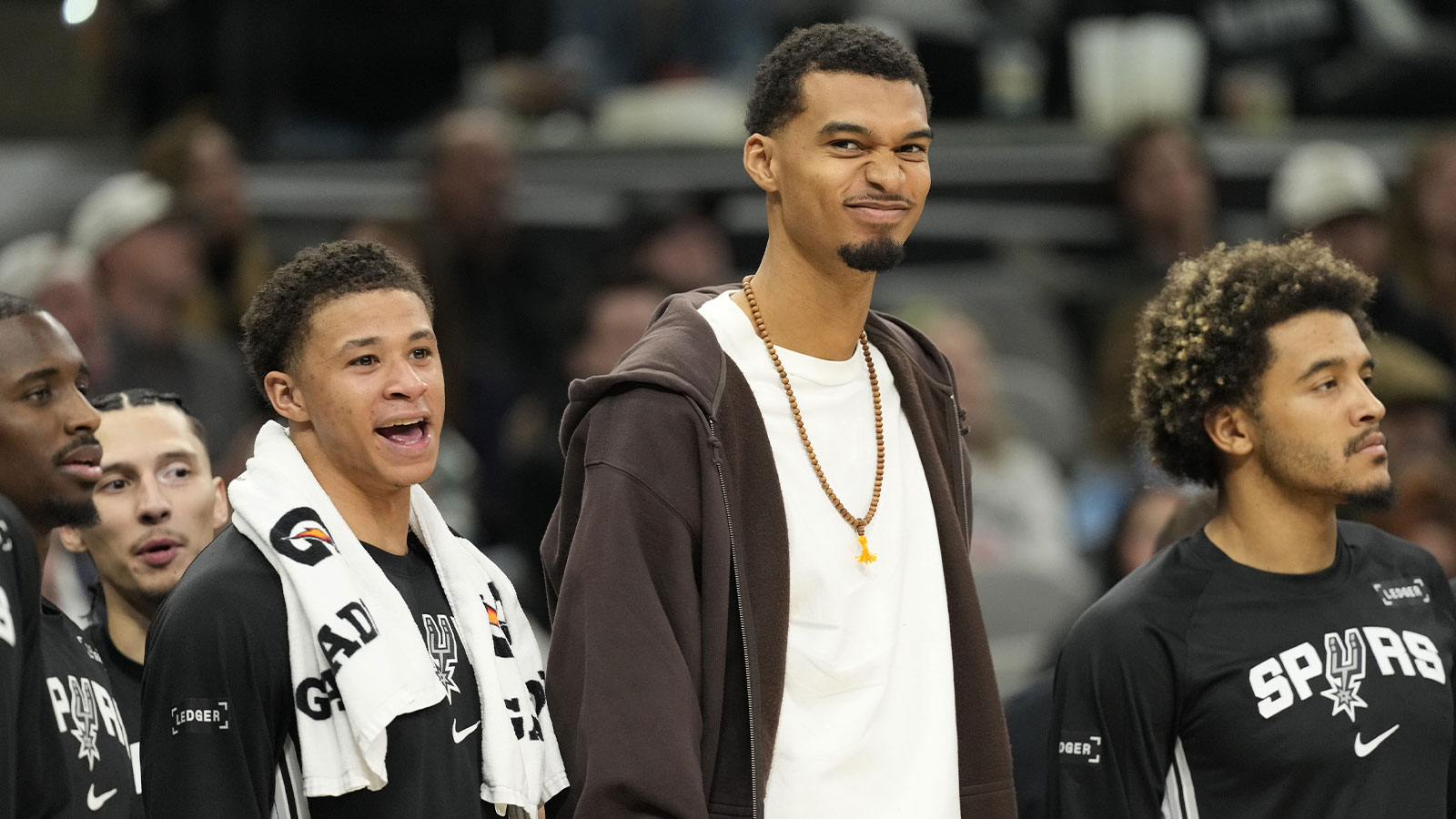 San Antonio Spurs forward Victor Wembanyama (1) along with forward Carter Bryant (11) react from the bench during the second half against the Memphis Grizzlies at Frost Bank Center.