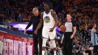 Warriors forward Draymond Green (23) walks towards the team bench with head coach Steve Kerr after a play against the Memphis Grizzlies in the third quarter at the Chase Center with Kenyon Martin in the background
