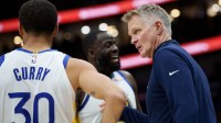 Warriors head coach Steve Kerr talks to guard Stephen Curry (30) and forward Draymond Green (23) during the first half against the New Orleans Pelicans at Smoothie King Center with ESPN's Tim Legler in the background