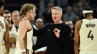 Warriors head coach Steve Kerr talks with guard Brandin Podziemski (2) during a time out against the Orlando Magic in the third quarter at Chase Center