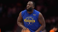 Warriors forward Draymond Green (23) warms up after halftime during the second half against the Charlotte Hornets at Spectrum Center with Suns' Mark Williams & Pelicans' Jose Alvarado