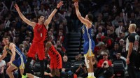 Golden State Warriors guard Stephen Curry (30) shoots the ball over Portland Trail Blazers forward Deni Avdija (8) during the second half at Moda Center.