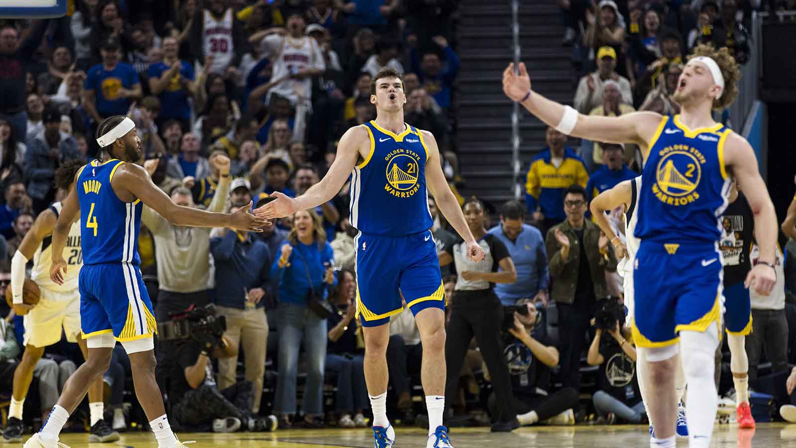 Golden State Warriors center Quinten Post (21) is congratulated by guard Moses Moody (4) after he scored against the Dallas Mavericks during the second quarter at Chase Center.