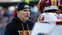 Washington Commanders head coach Dan Quinn speaks to his players in the second half against the Dallas Cowboys at Northwest Stadium.