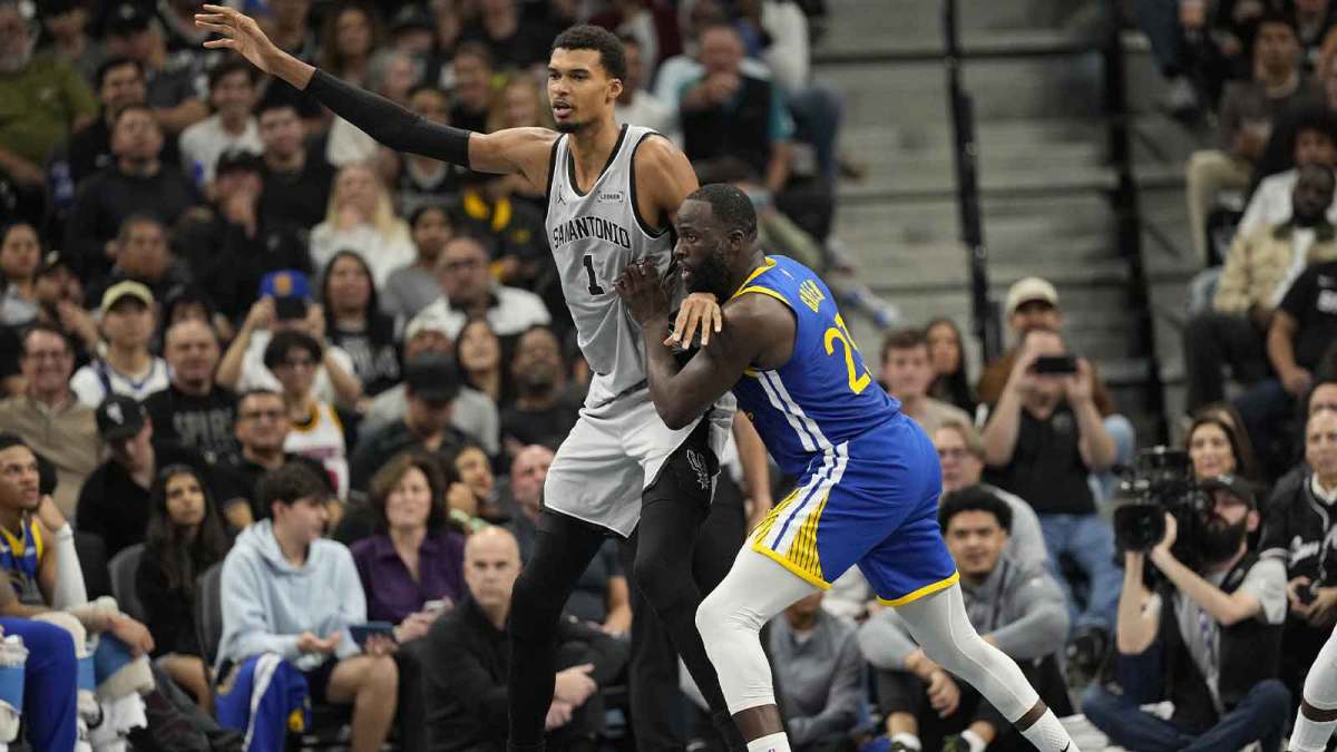San Antonio Spurs forward Victor Wembanyama (1) posts up on Golden State Warriors forward Draymond Green (23) during the first half at Frost Bank Center.