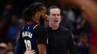 Cleveland Cavaliers head coach Kenny Atkinson talks with Cleveland Cavaliers guard Darius Garland (10) during the second half against the Boston Celtics at Rocket Arena.