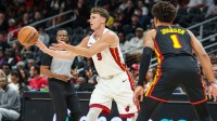 Miami Heat guard Pelle Larsson (9) makes a pass against Atlanta Hawks forward Jalen Johnson (1) during the first quarter at State Farm Arena.