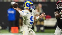 Los Angeles Rams quarterback Matthew Stafford (9) throws an interception to Atlanta Falcons safety Jessie Bates III (3) (not shown) during the first half at Mercedes-Benz Stadium.