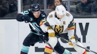 Seattle Kraken forward Eeli Tolvanen (20) and Vegas Golden Knights forward William Karlsson (71) battle for the puck during the third period at Climate Pledge Arena.
